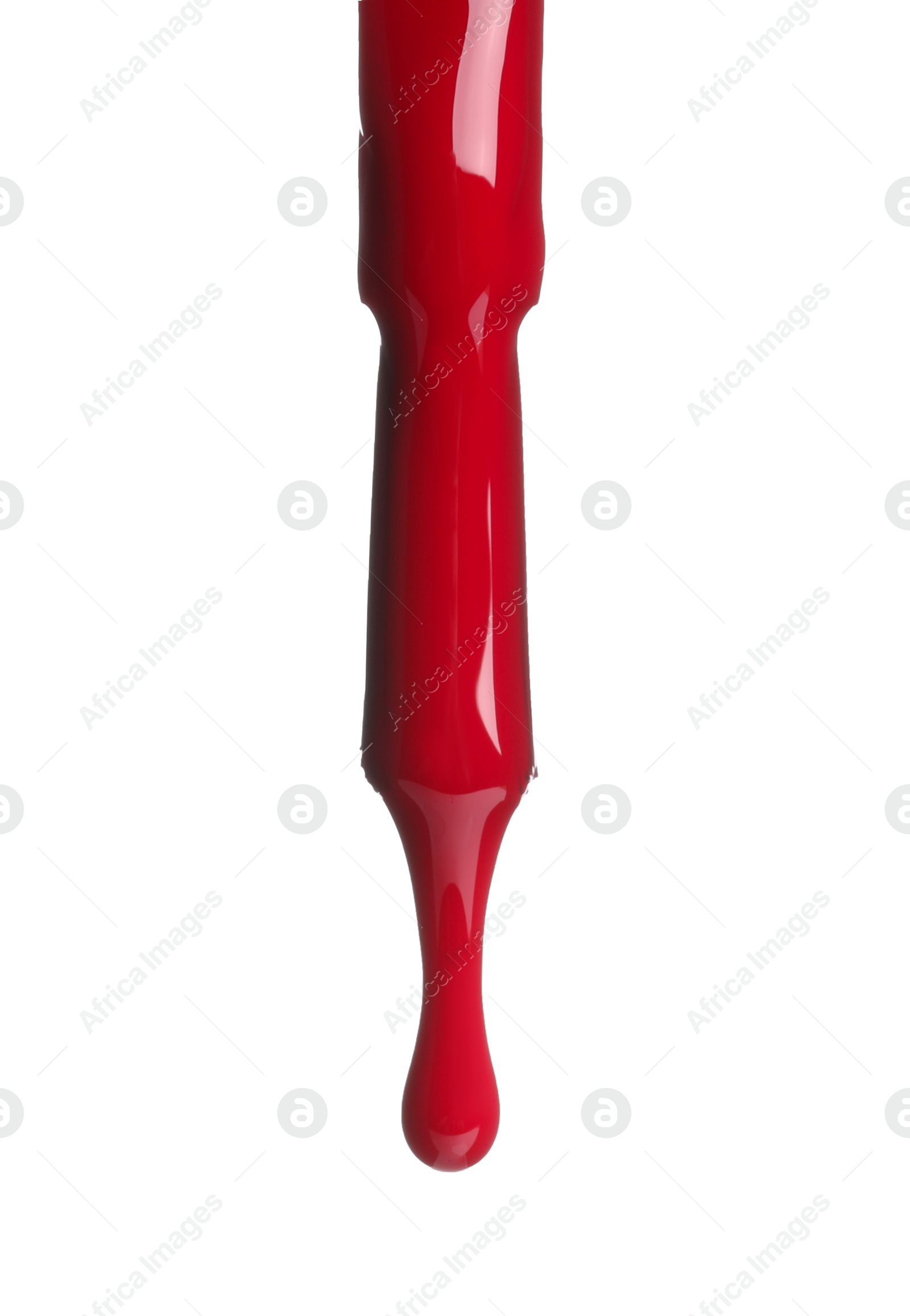Photo of Red nail polish dripping from brush isolated on white