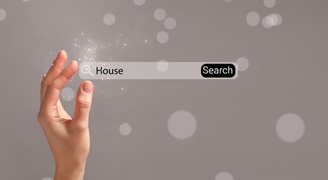 Image of House hunting. Woman holding virtual search bar on grey background, closeup. Banner design