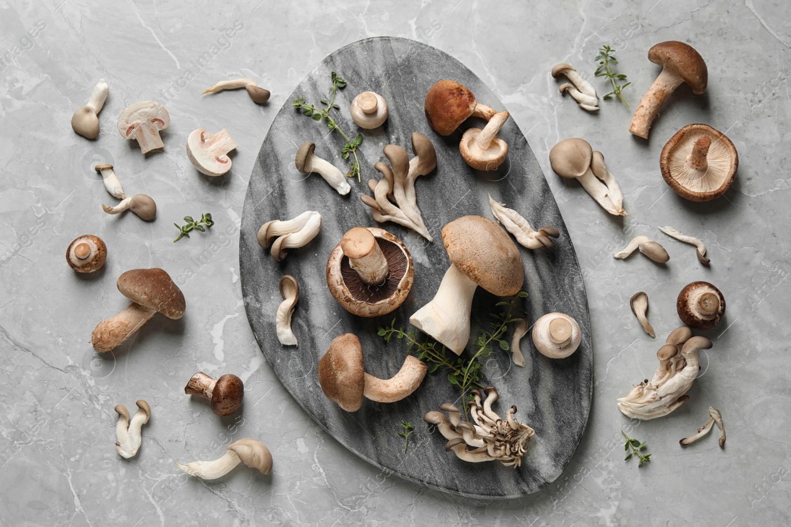 Photo of Flat lay composition with fresh wild mushrooms on light grey table