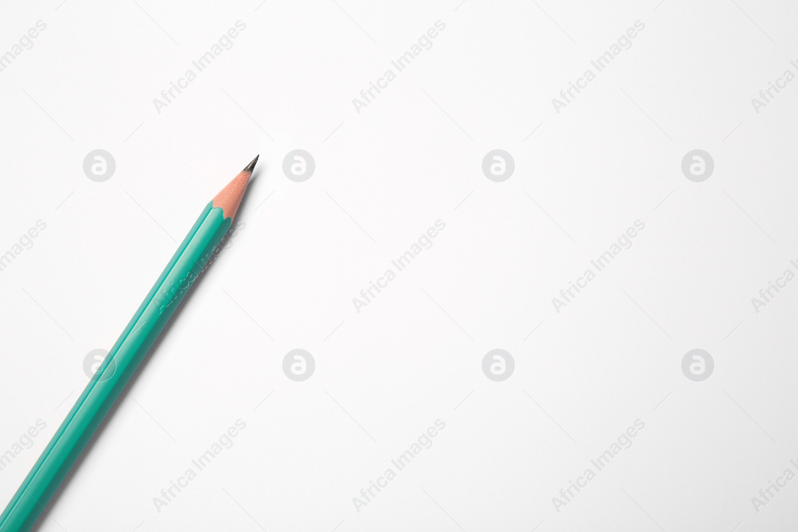 Photo of Sharp graphite pencil on white background, top view. Space for text