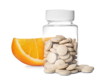 Photo of Bottle with vitamin pills and orange on white background