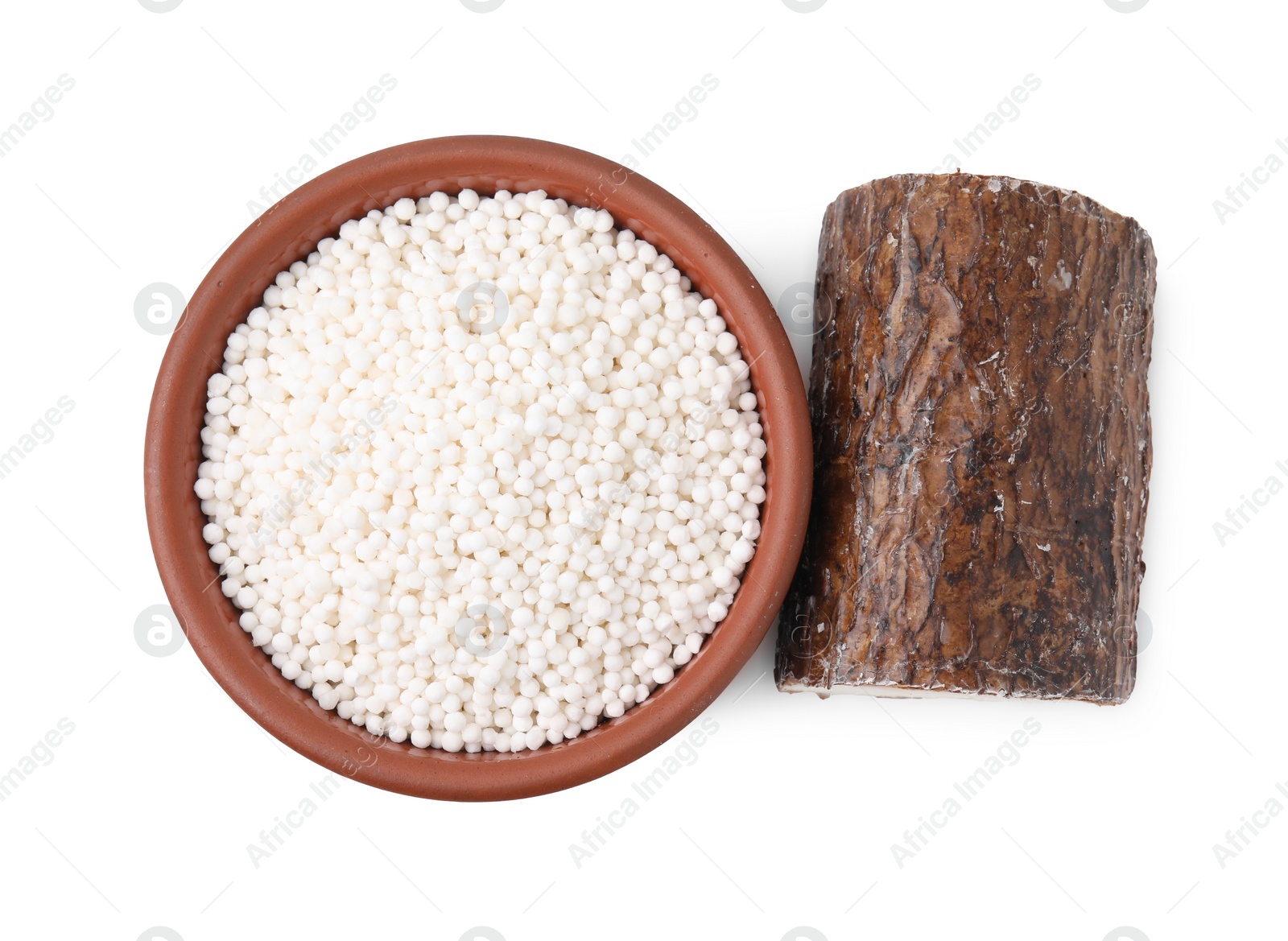 Photo of Tapioca pearls in bowl and cassava root isolated on white, top view