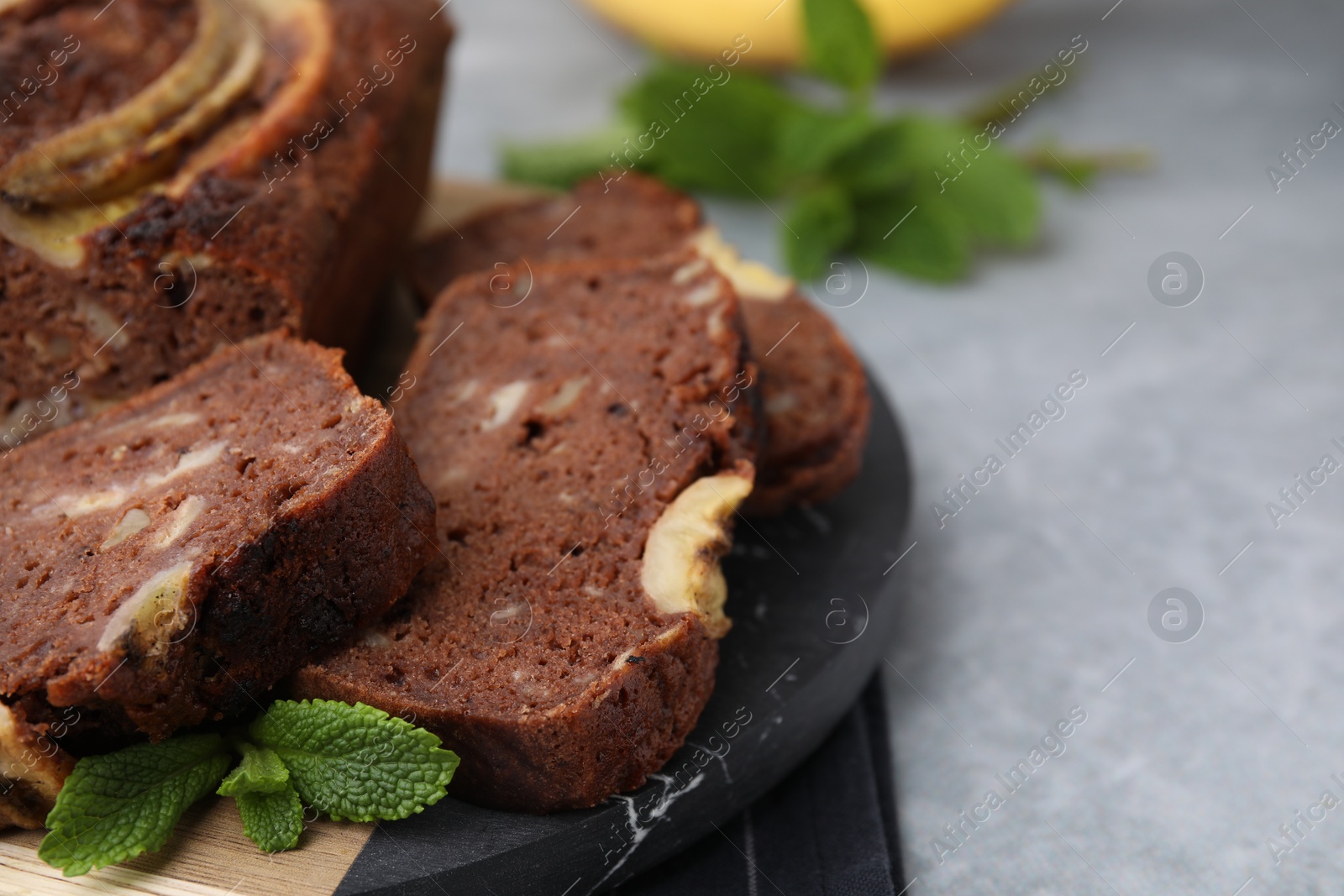 Photo of Delicious banana bread on grey table, closeup. Space for text
