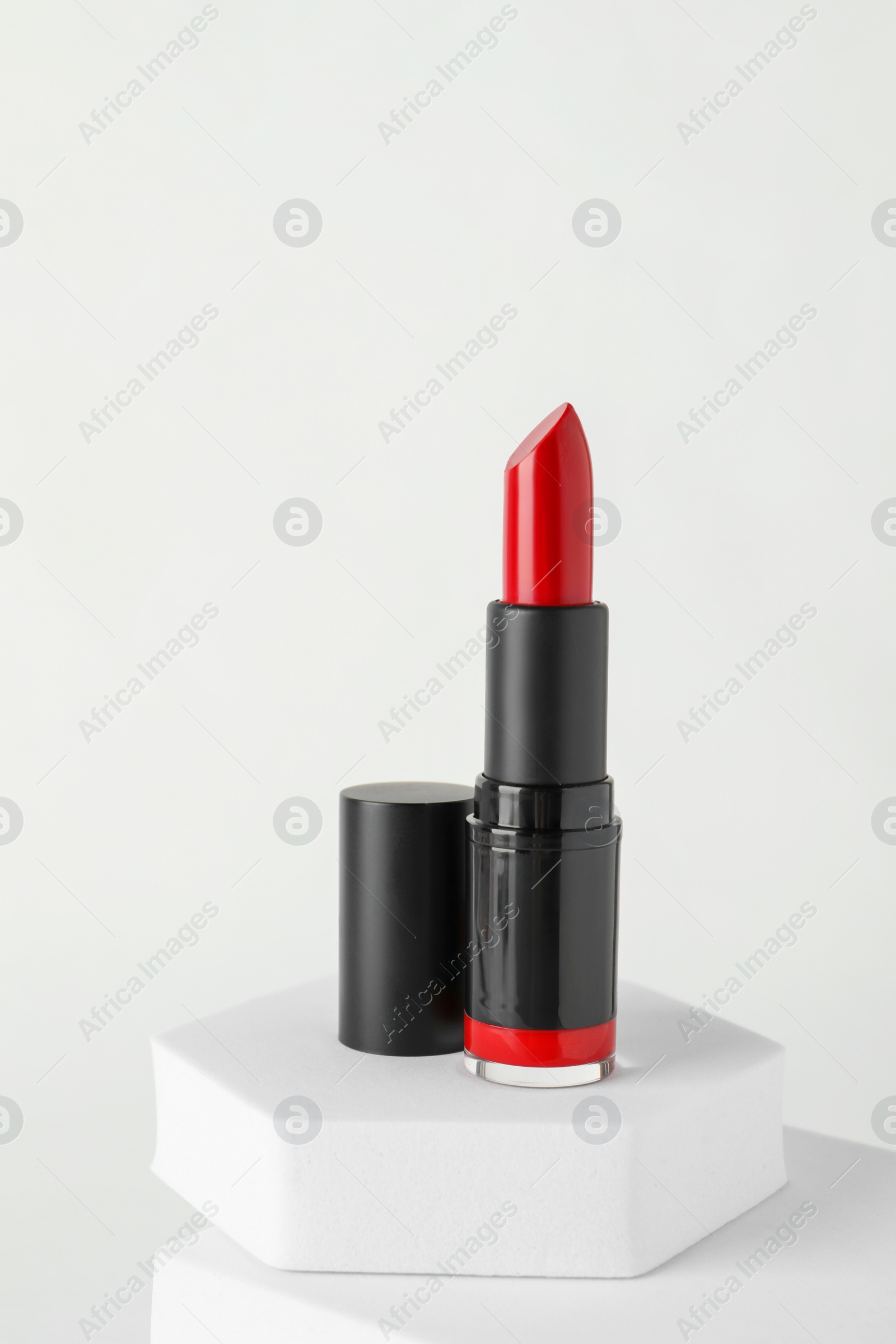 Photo of Beautiful glossy red lipstick on white background