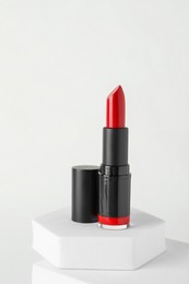 Photo of Beautiful glossy red lipstick on white background