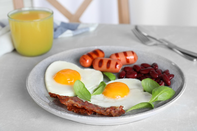 Photo of Tasty breakfast with heart shaped fried eggs served on kitchen table