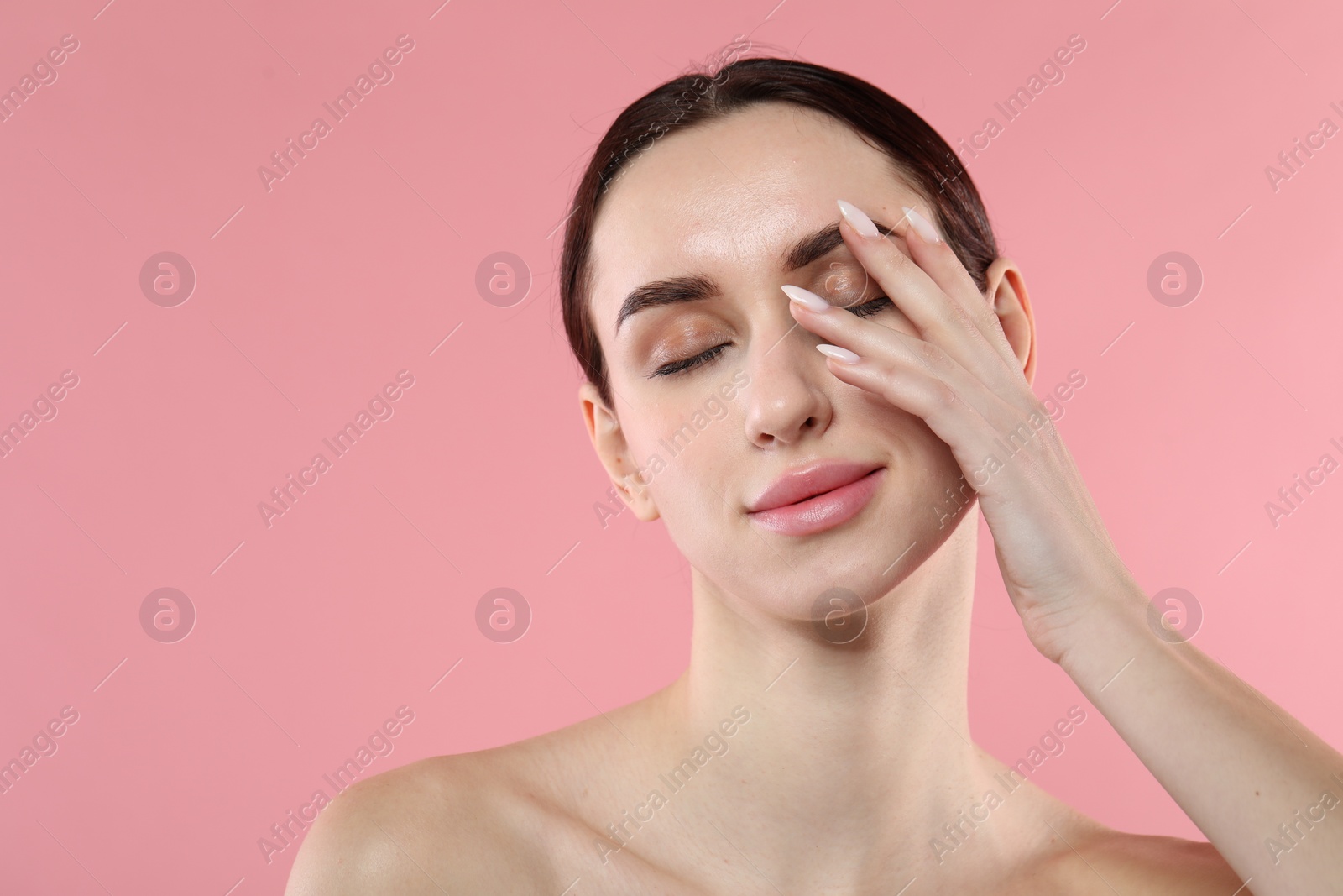 Photo of Portrait of beautiful young woman on pink background. Space for text