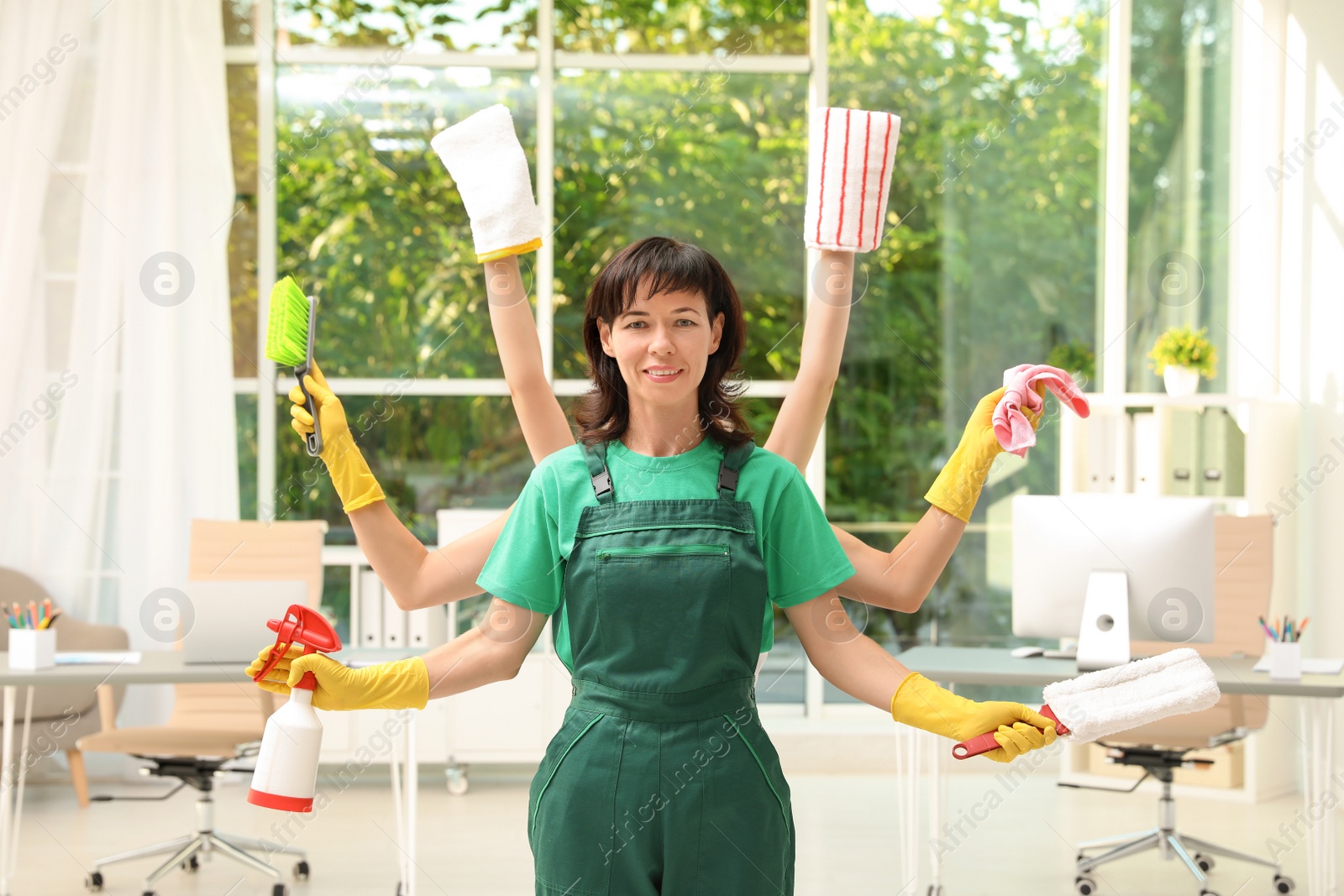 Photo of Woman with many hands holding cleaning supplies in office