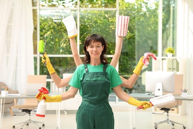 Woman with many hands holding cleaning supplies in office