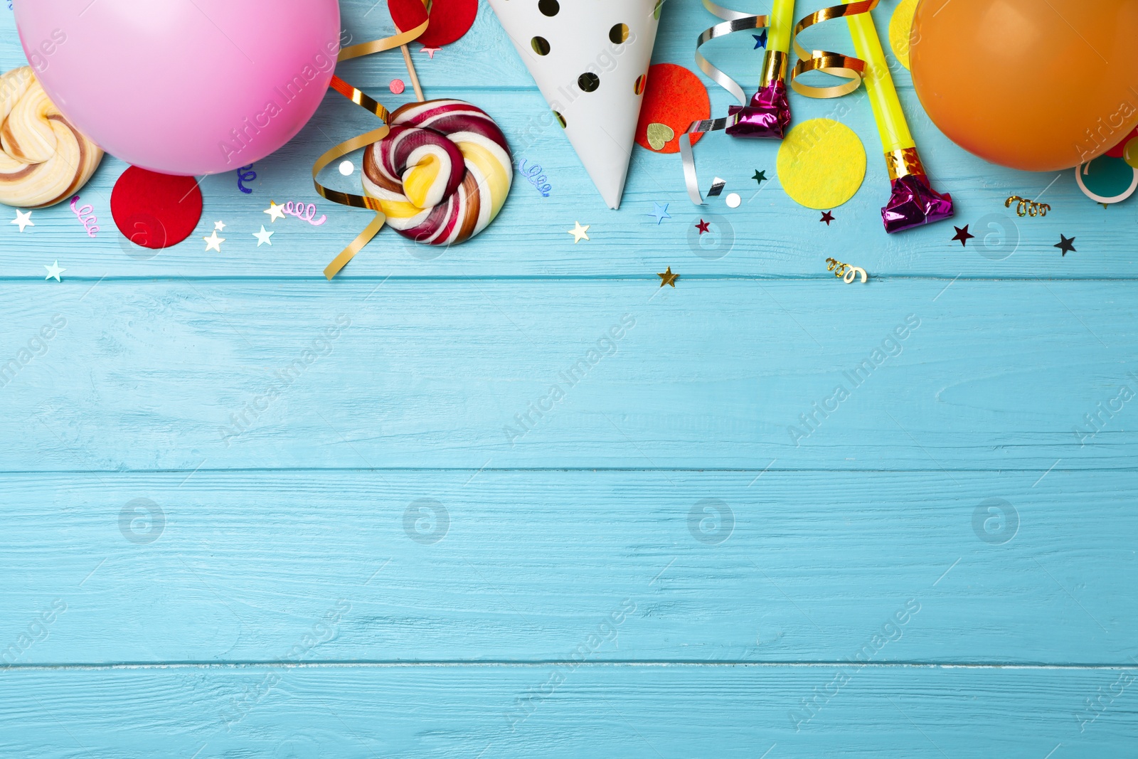 Photo of Flat lay composition with birthday party items on wooden background