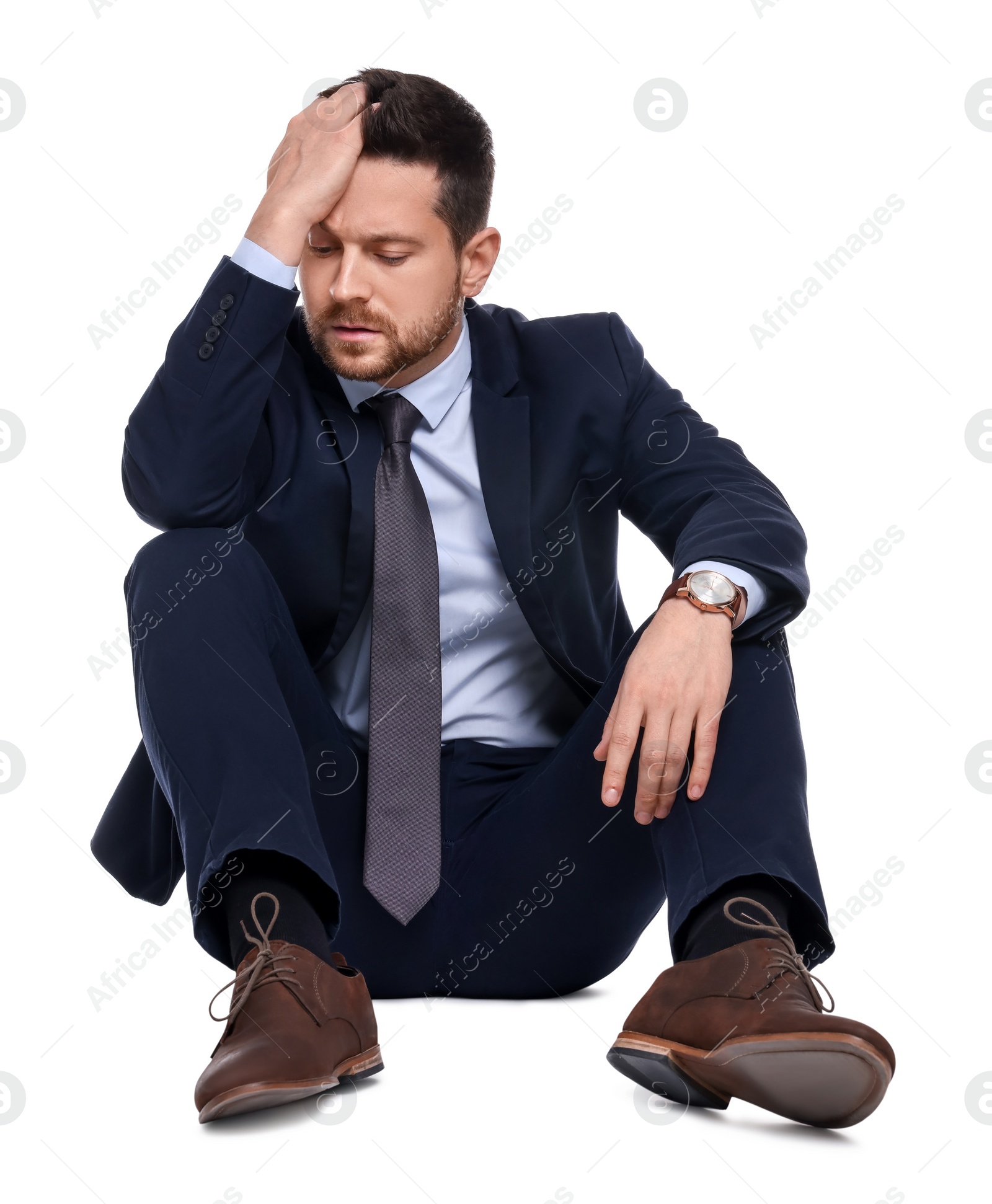 Photo of Upset bearded businessman in suit on white background