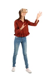 Young woman using cardboard virtual reality headset, isolated on white