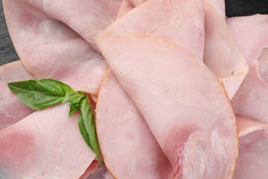 Slices of tasty ham and basil, closeup view