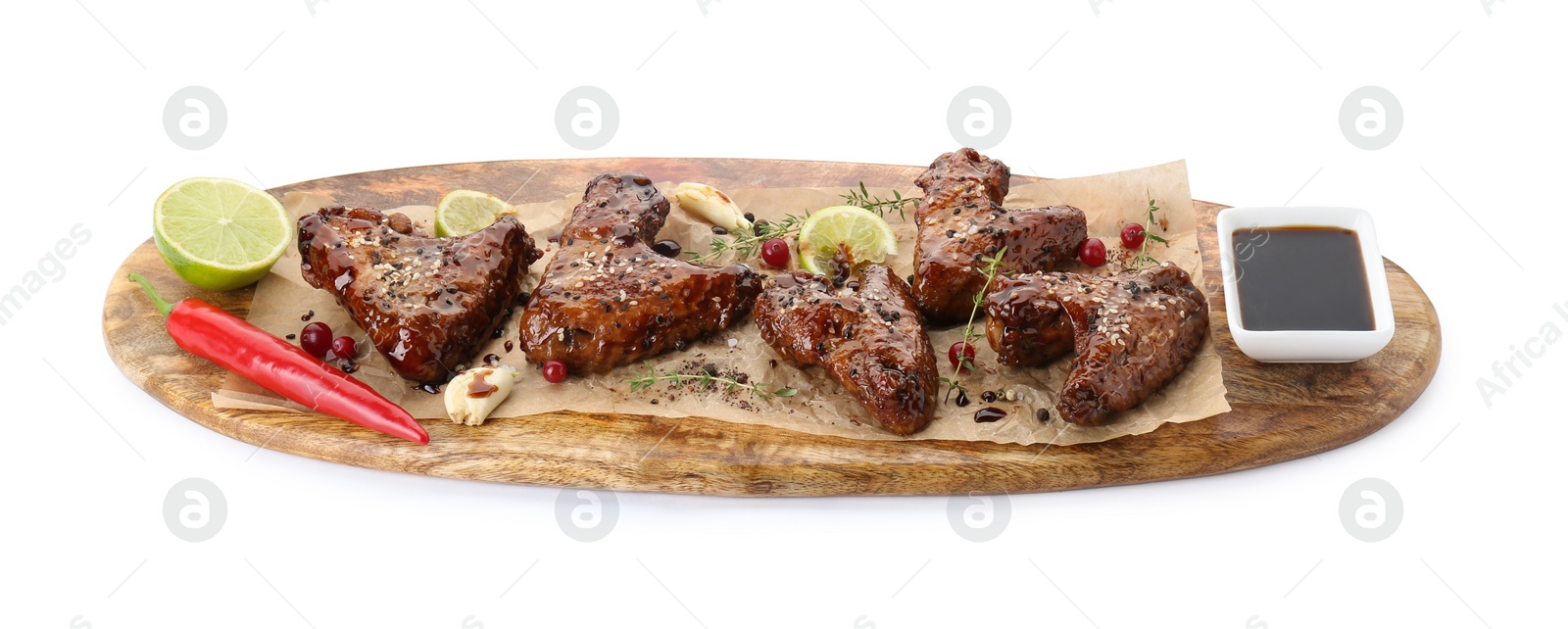 Photo of Tasty chicken wings glazed in soy sauce with garnish isolated on white
