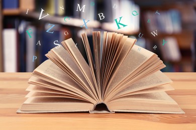 Open book with letters flying out of it in library