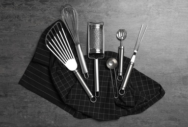 Photo of Set of cooking utensils on grey table, flat lay