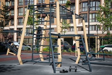 Photo of Empty outdoor gym with different sport simulators in residential area