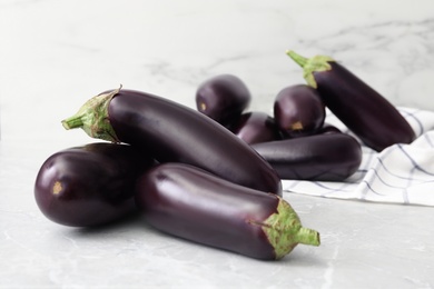 Photo of Many raw ripe eggplants on grey table