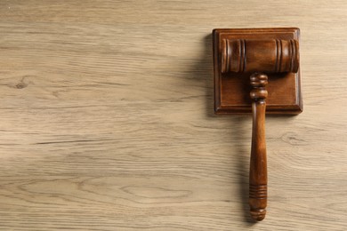 Photo of Wooden gavel and sound block on table, top view. Space for text