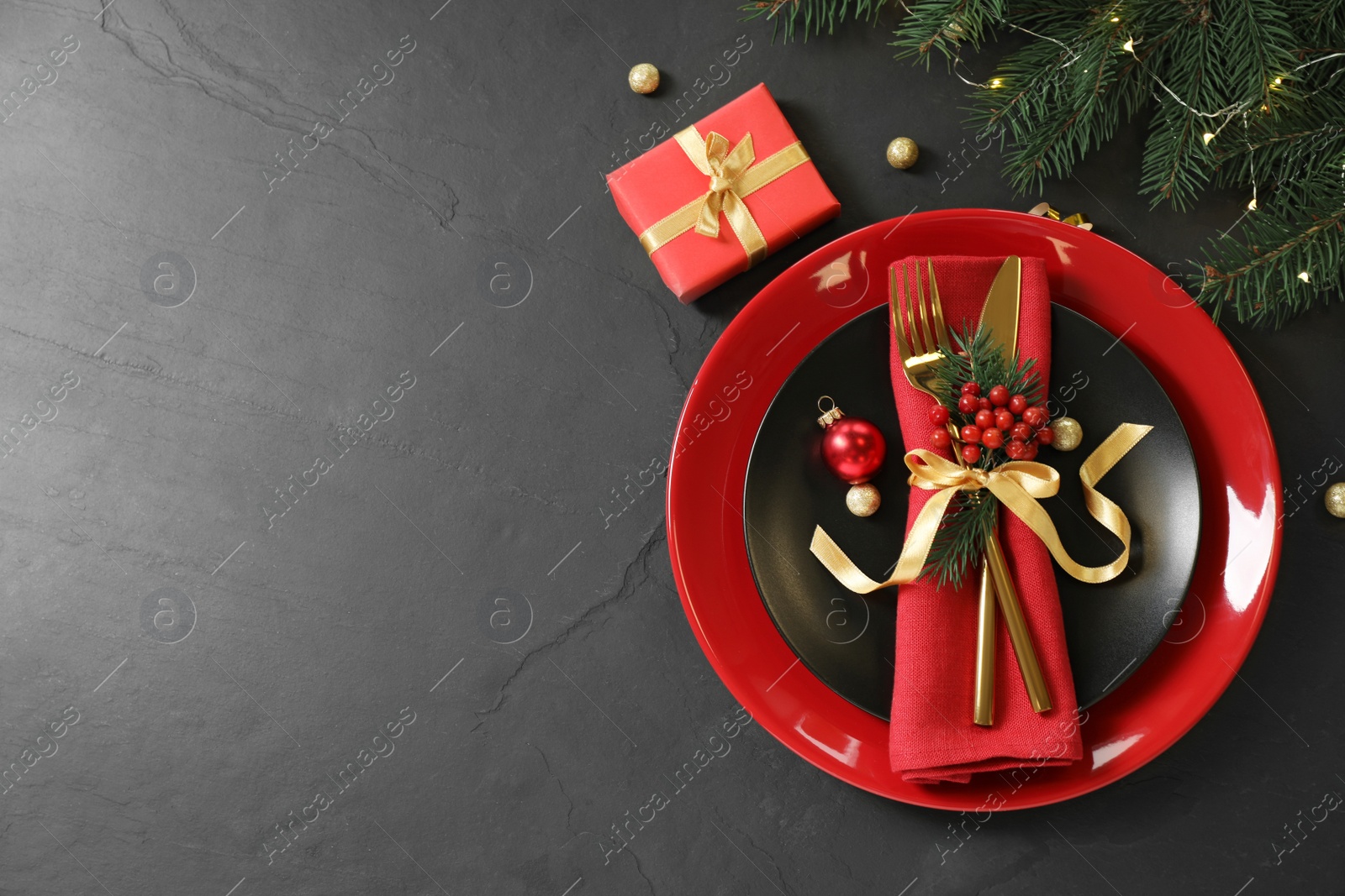 Photo of Beautiful Christmas table setting on black background, top view. Space for text