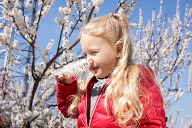 Photo of Happy healthy little girl enjoying springtime outdoors. Allergy free concept