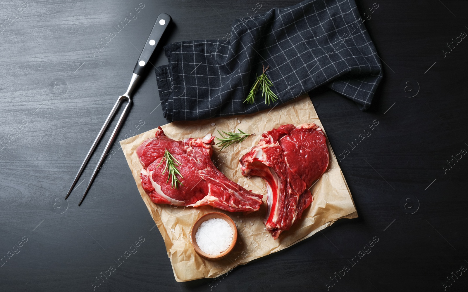 Photo of Flat lay composition with fresh meat on black wooden table