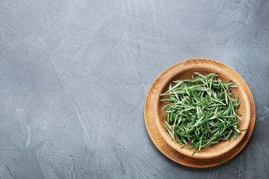 Photo of Fresh rosemary on grey table, top view. Space for text