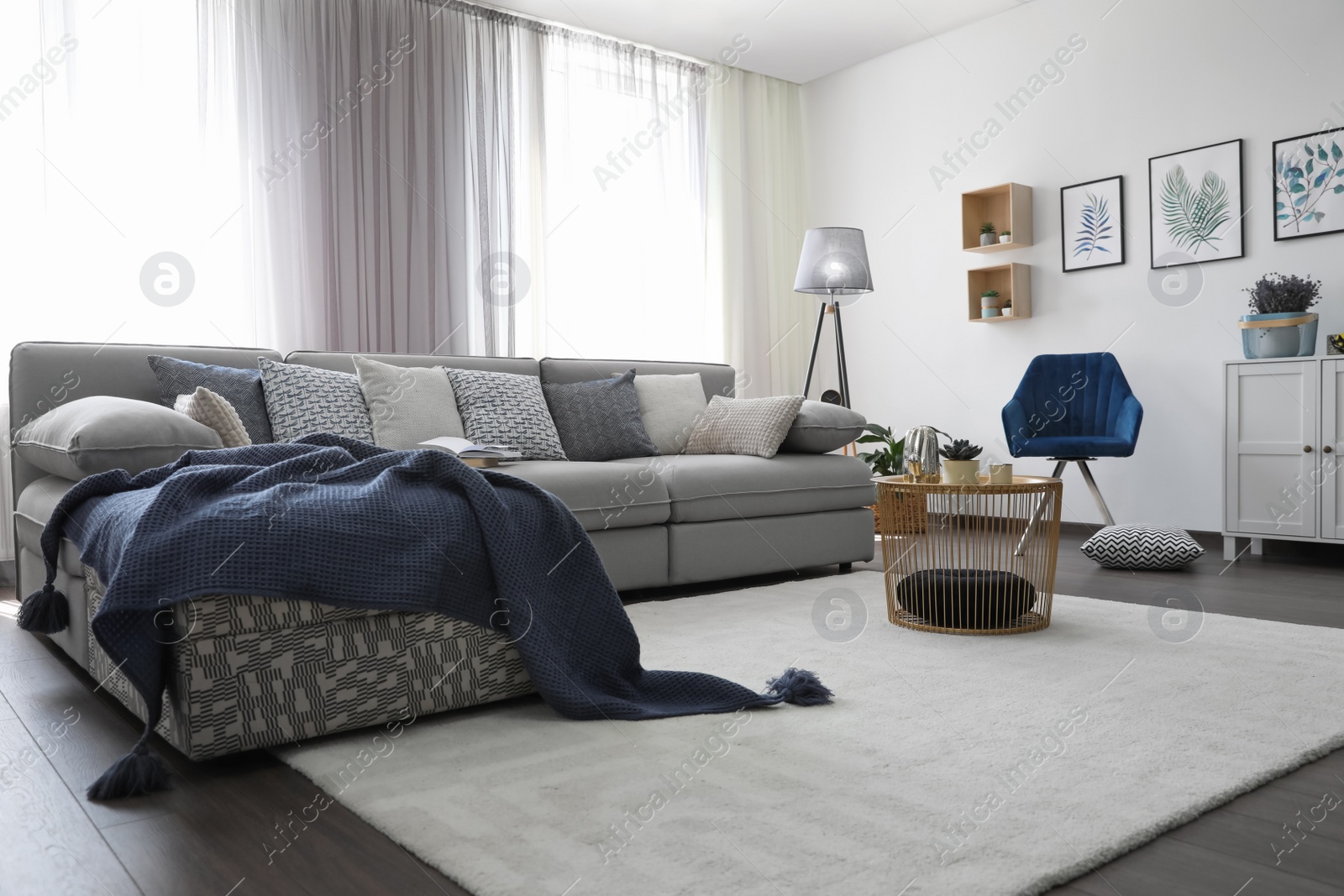 Photo of Elegant living room with comfortable sofa near windows. Interior design