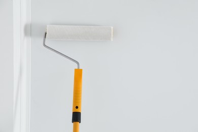 Painting ceiling with white dye indoors, bottom view. Space for text