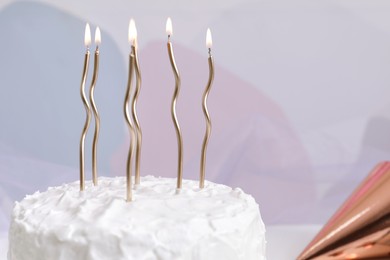 Photo of Delicious cake with cream and burning candles on color background, closeup. Space for text