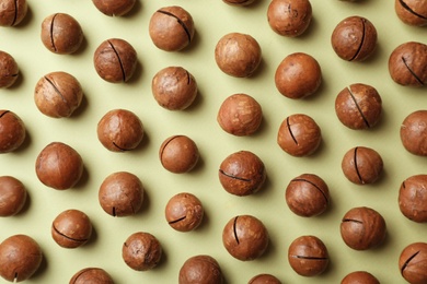 Photo of Flat lay composition with organic Macadamia nuts on color background