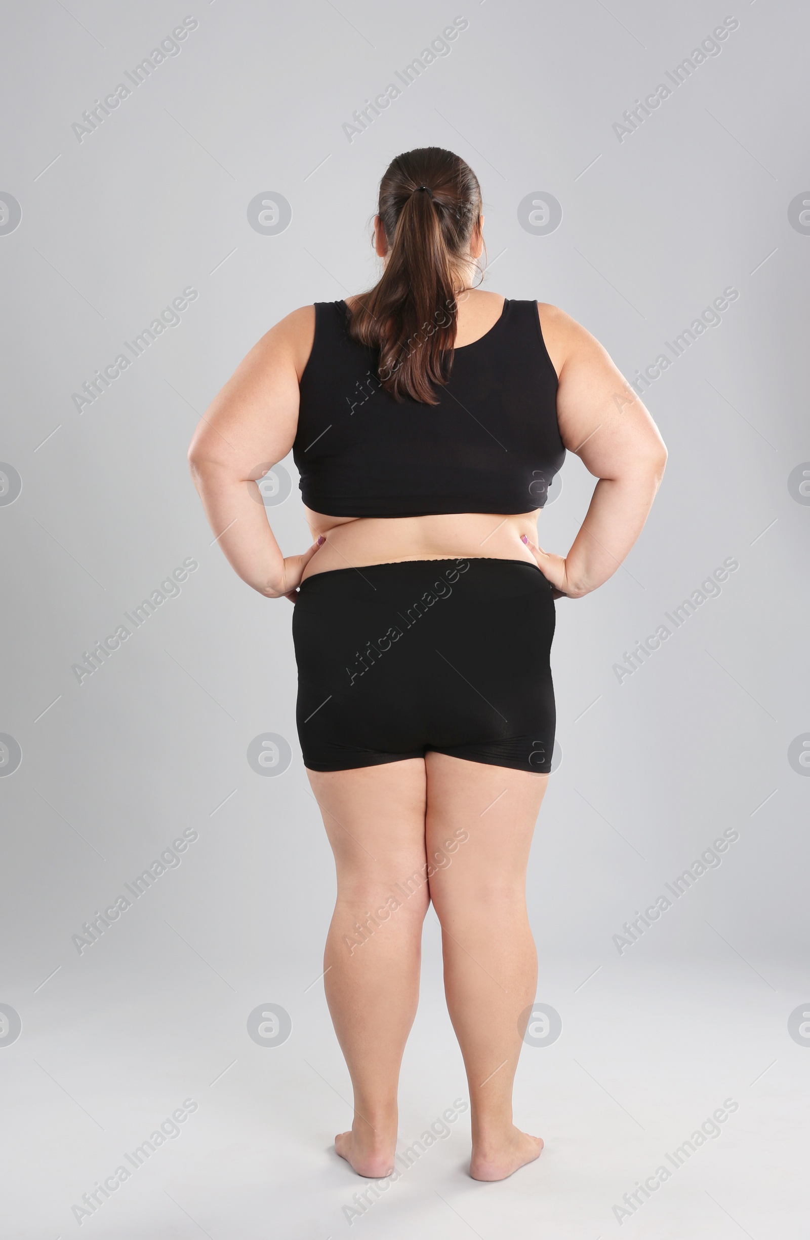 Photo of Overweight woman before weight loss on color background