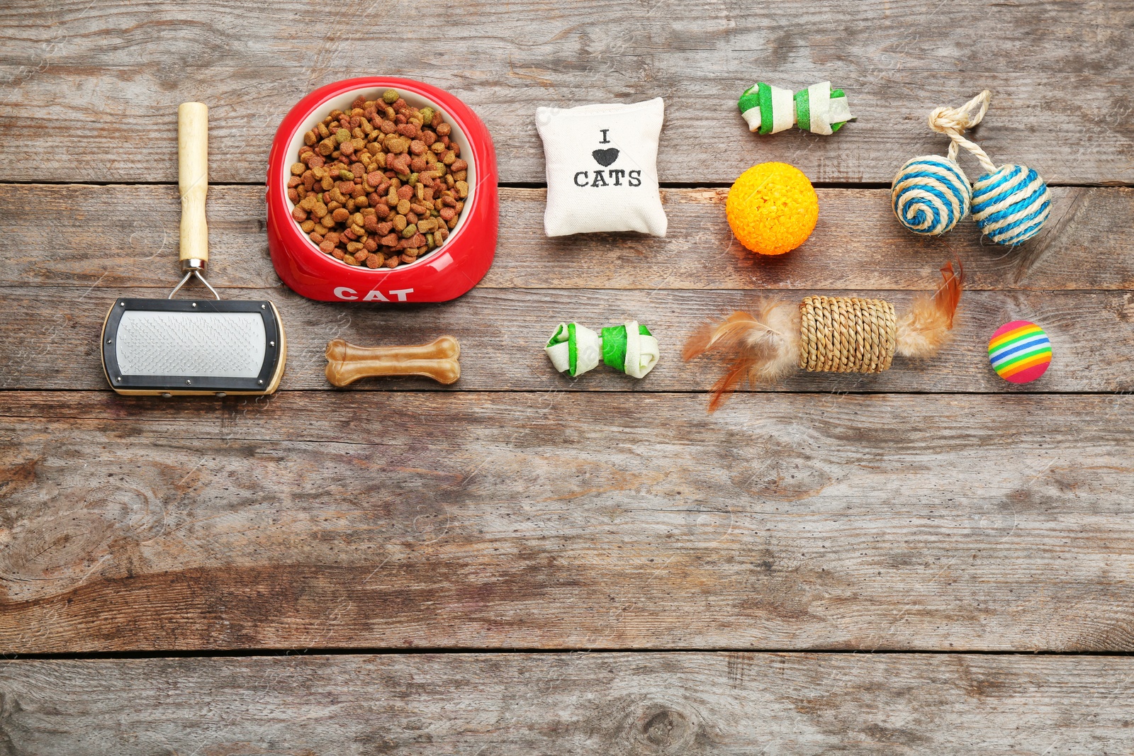 Photo of Flat lay composition with cat accessories and food on wooden background