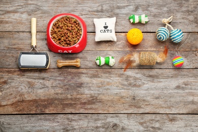 Photo of Flat lay composition with cat accessories and food on wooden background