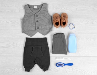 Photo of Flat lay composition with stylish child clothes on light background