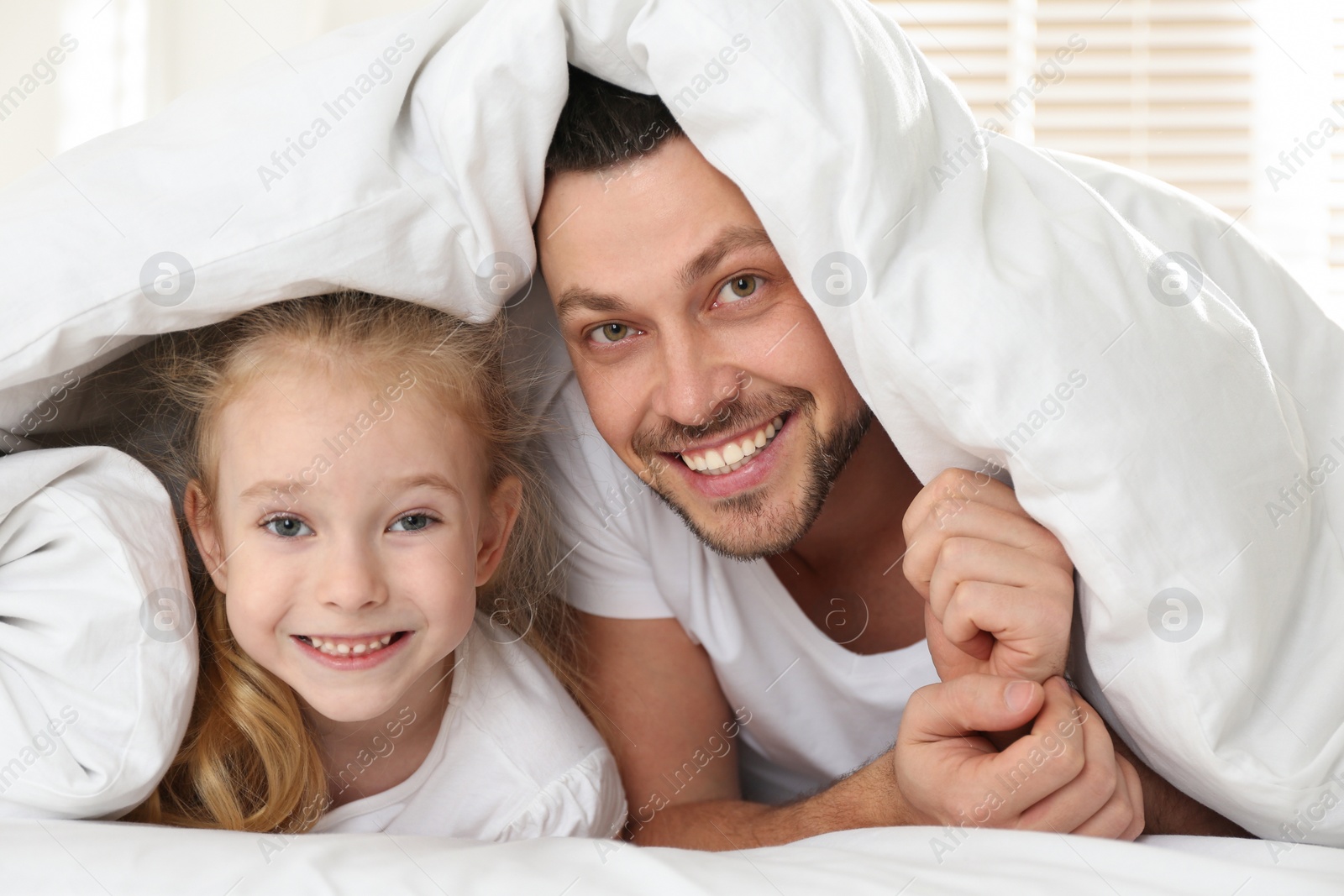 Photo of Dad and daughter spending time together at home. Happy Father's Day