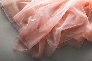 Photo of Beautiful tulle fabric on grey background, top view