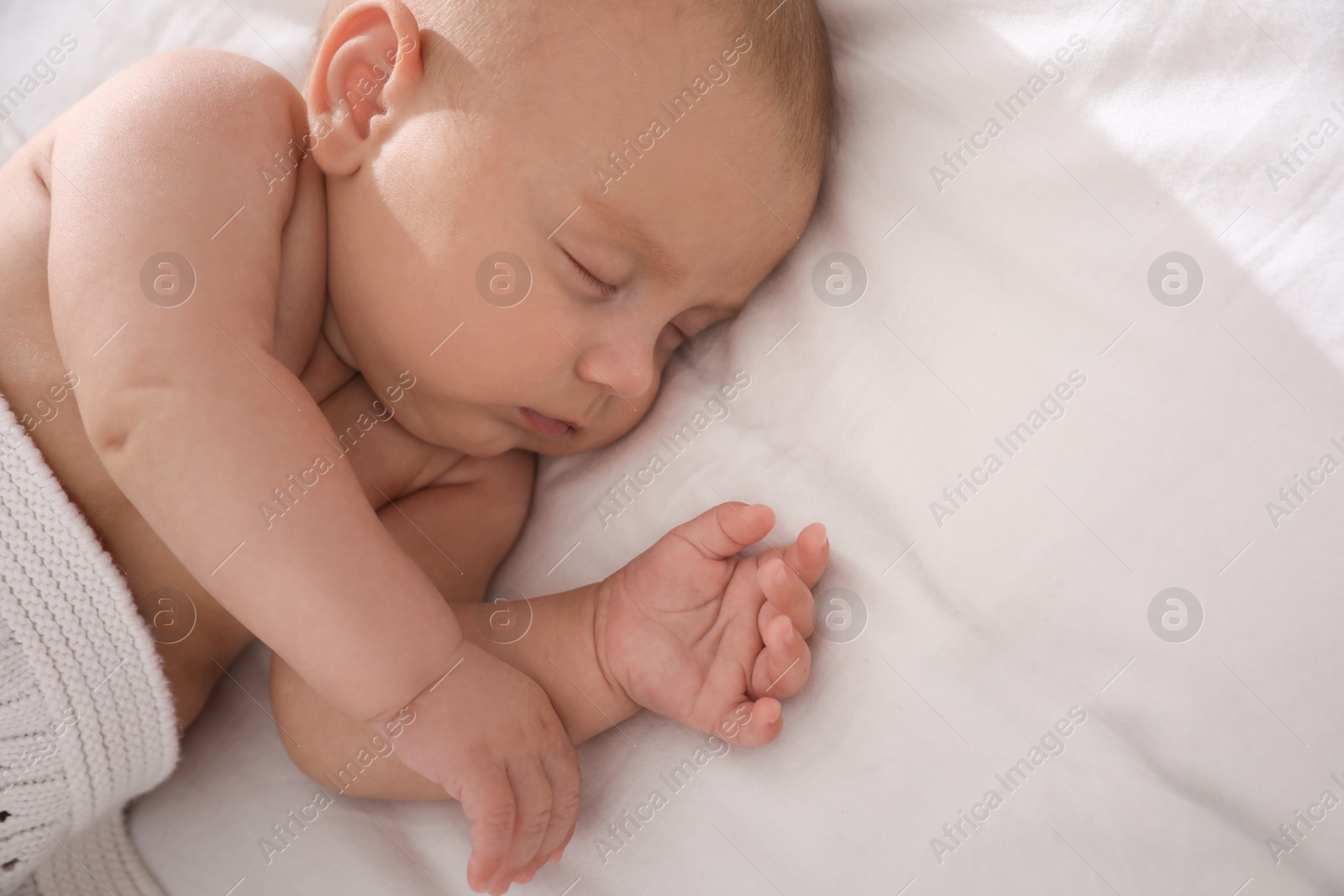 Photo of Cute little baby sleeping in bed. Space for text