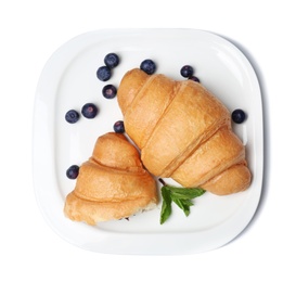 Photo of Plate with tasty croissants and berries on white background, top view