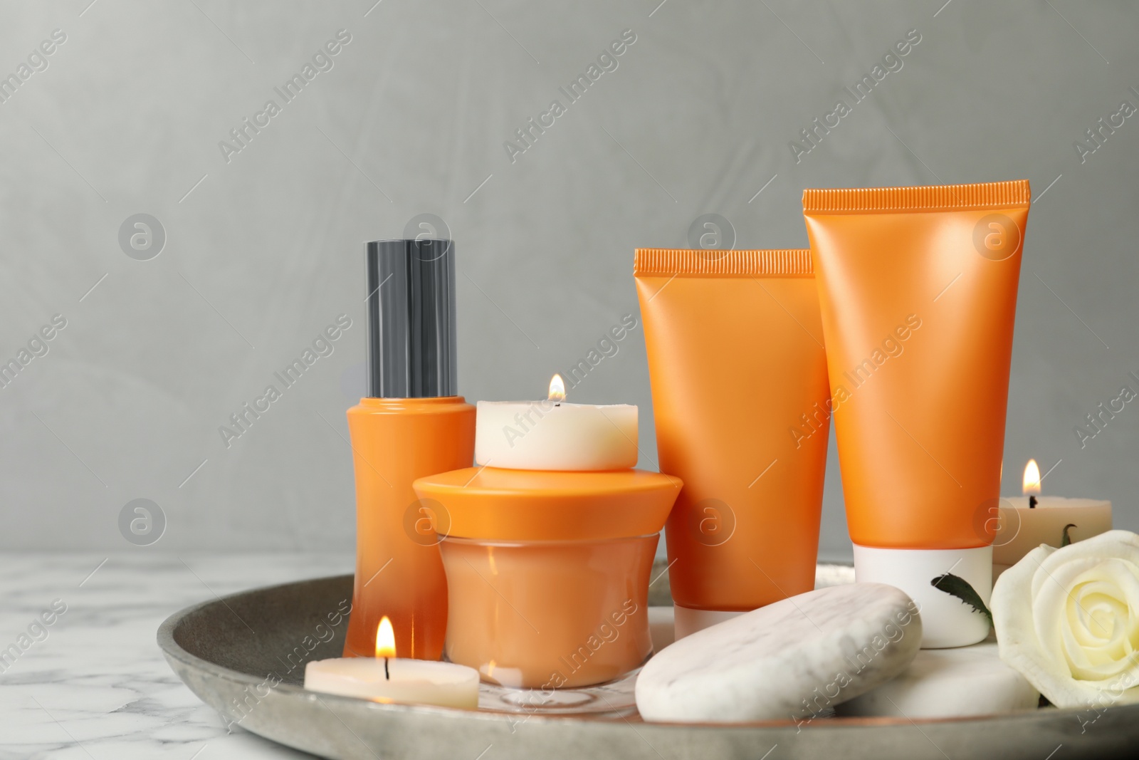 Photo of Composition with cosmetic products on white marble table