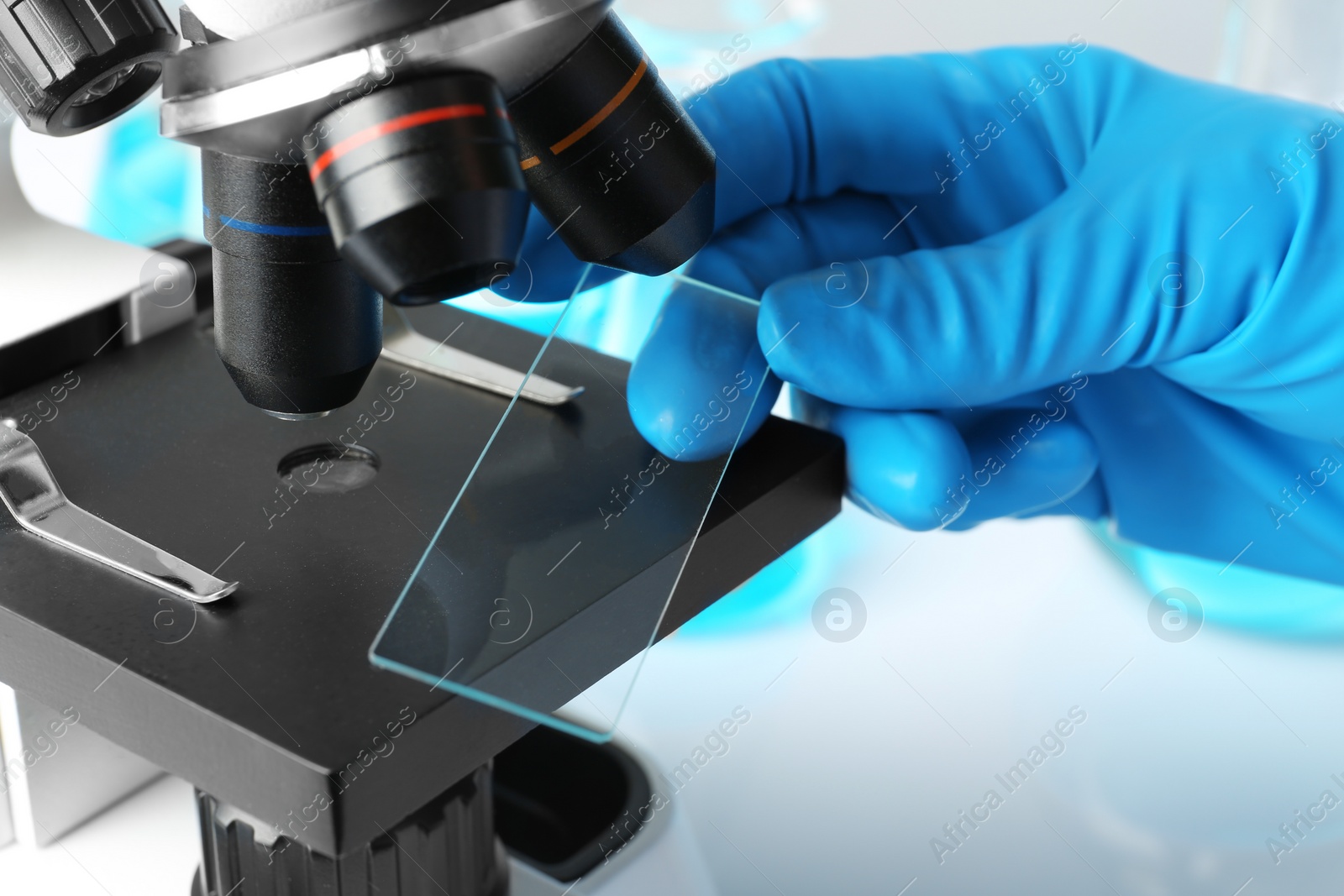 Photo of Scientist working with modern microscope, closeup. Chemical research