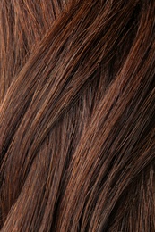 Texture of healthy brown hair as background, closeup