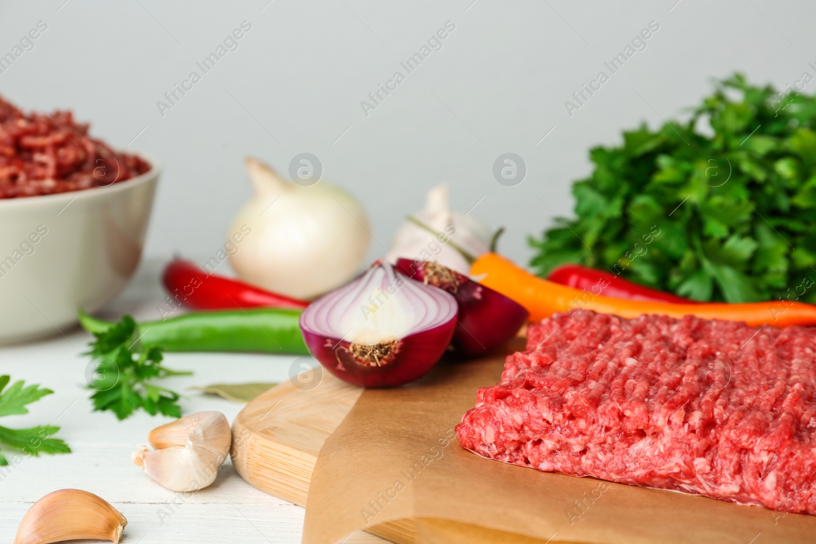Photo of Fresh raw minced meat and vegetables on table