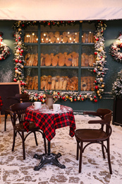 Photo of Beautiful outdoor cafe with festive decoration. Christmas celebration