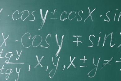 Photo of Many different math formulas written on chalkboard