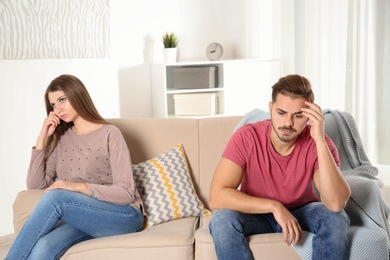 Photo of Young couple with relationship problems in living room