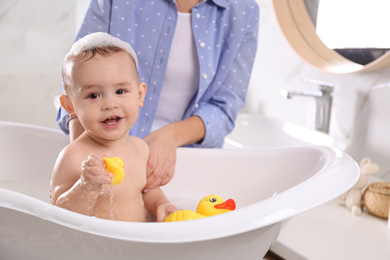 Mother with her little baby in bathroom