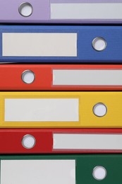 Photo of Many bright office folders as background, closeup