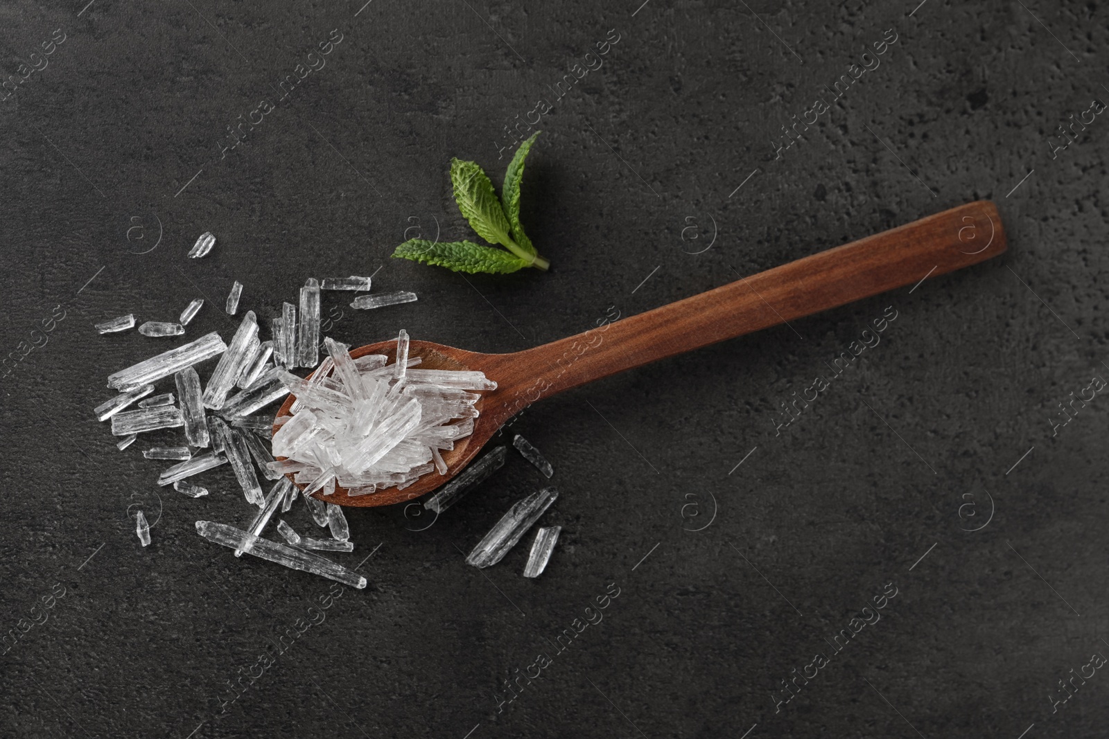 Photo of Menthol crystals and mint leaves on grey background, flat lay