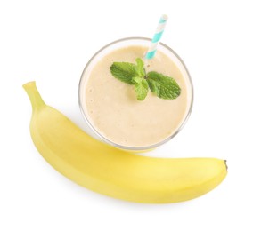 Glass with smoothie and banana on white background, top view
